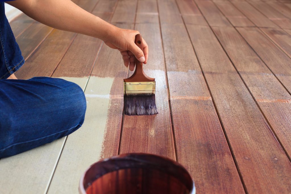 someone doing staining the deck