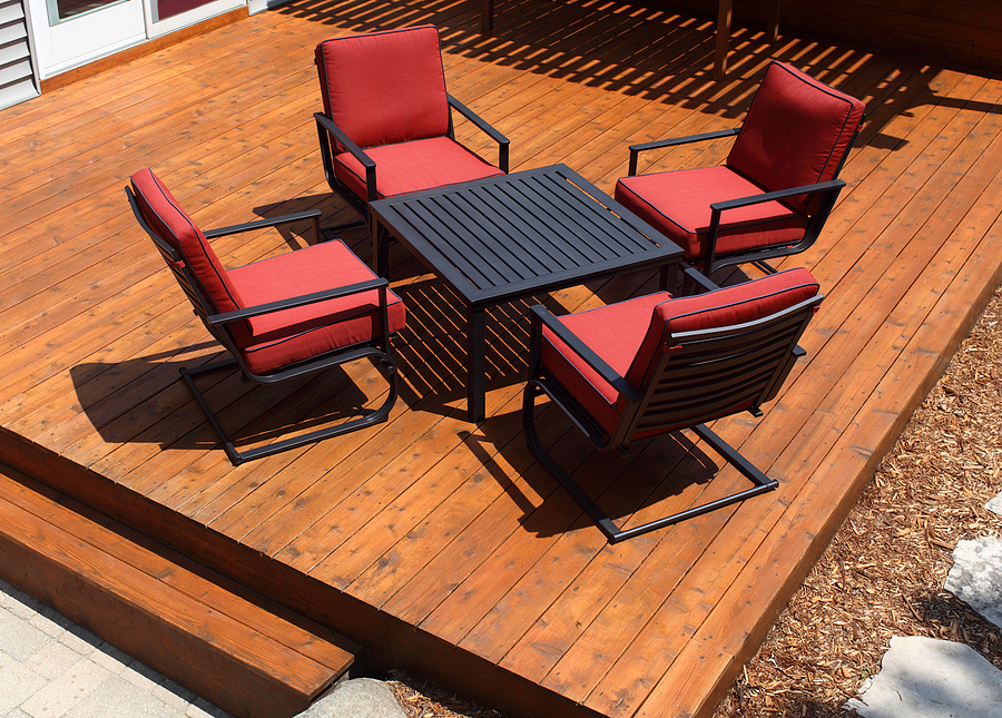 backyard deck design with furniture on freshly stained deck.